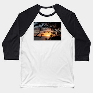 Sunrise over coast framed by silhouette foliage of pohutukawa tree on edge of slope. Baseball T-Shirt